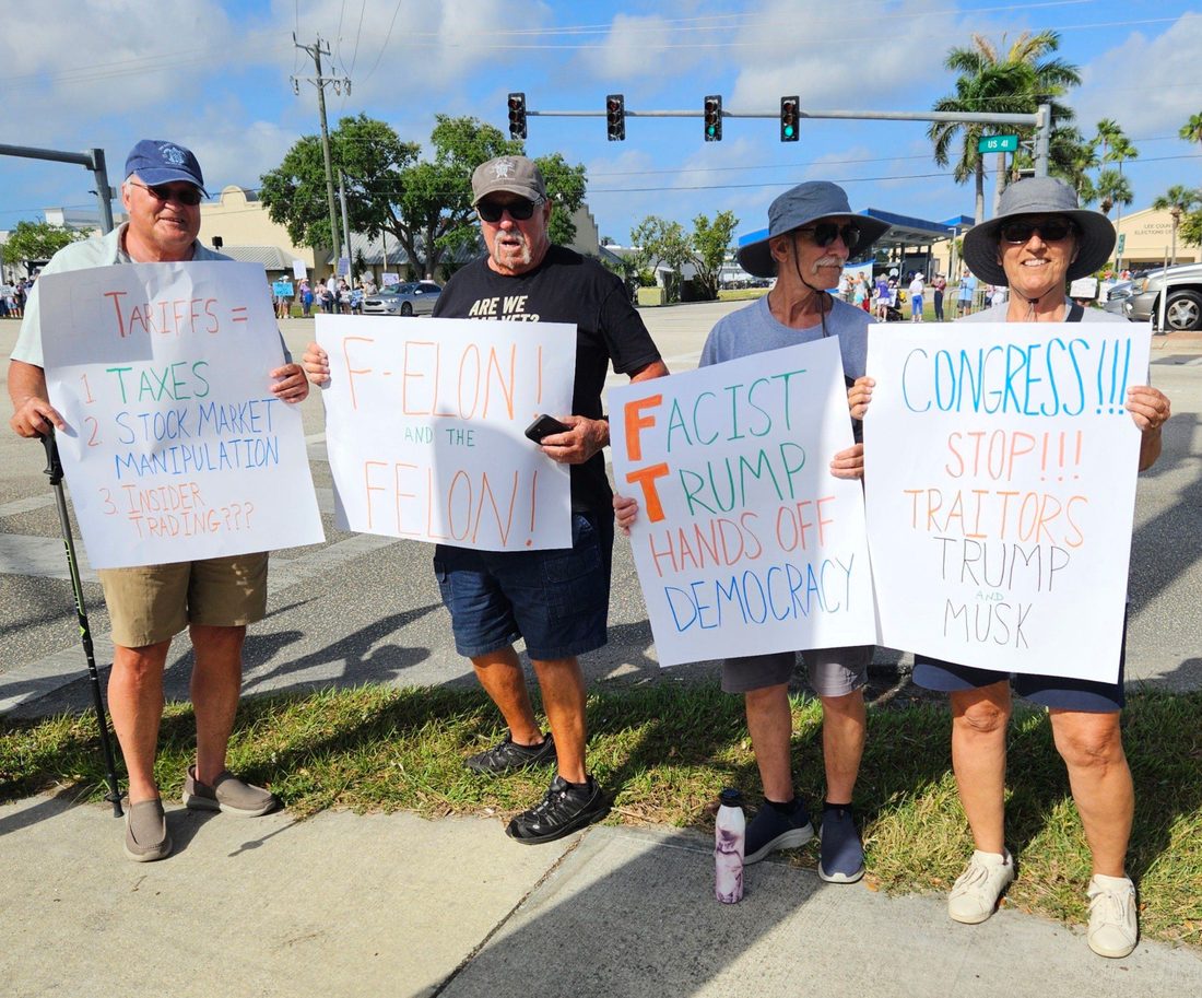 People participating in a public demonstration with protest signs