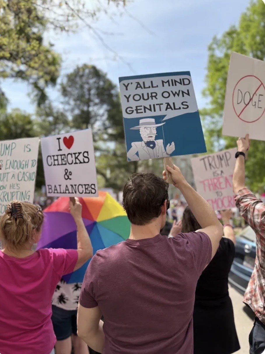 People carrying protest signs during a march